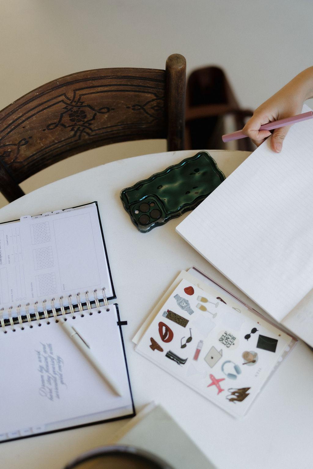 A planner and client notes on a desk