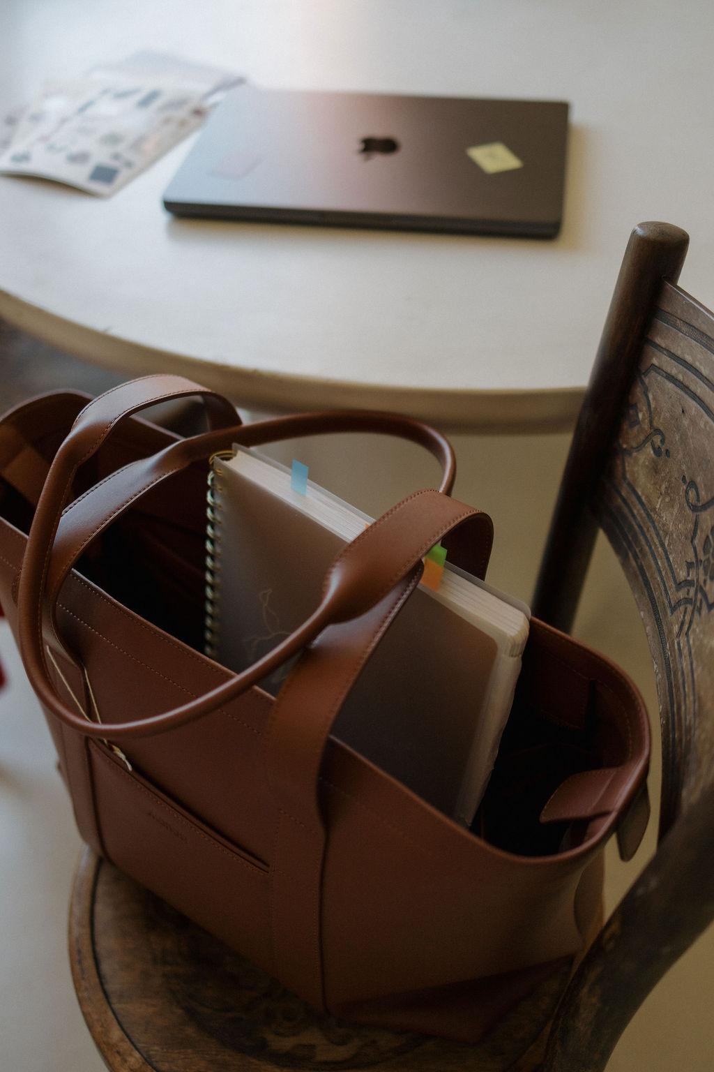 A leather work bag on a chair