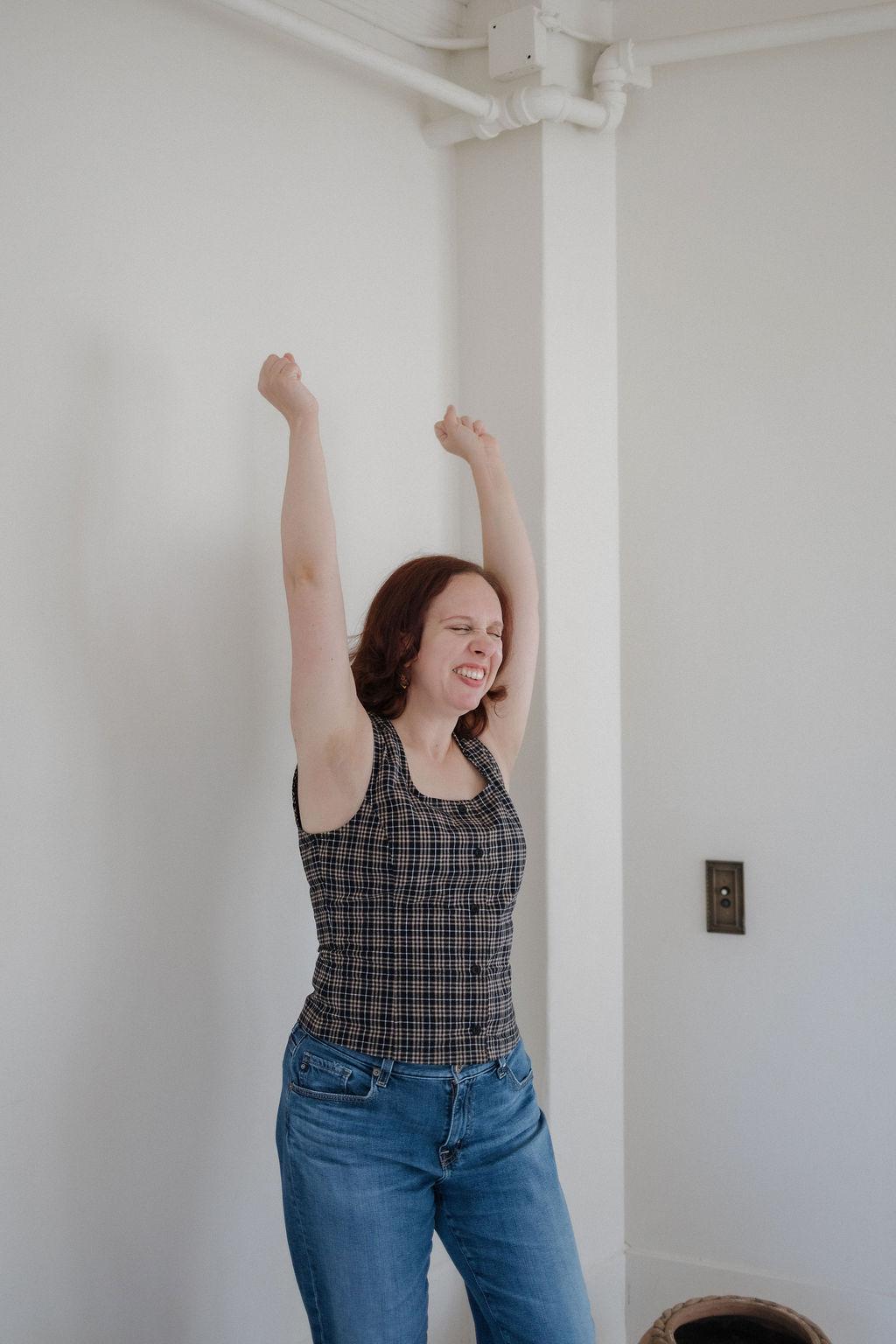 Kathleen stretching her arms overhead